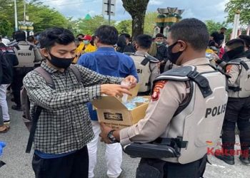 Meski Sempat Dilempari, Polisi Bagikan Air Minum Untuk Pendemo di Gedung DPRD Kalteng