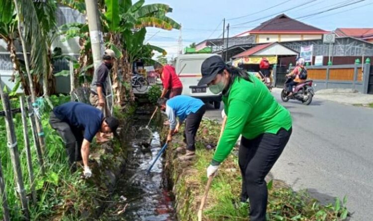 Kepala DLH Kabupaten Kapuas Kusmiatie, turun langsung bersama petugas kebersihan membersihkan drainase
