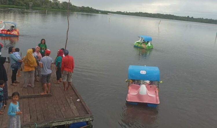 Foto// Pengunjung saat antri menggunakan bebek sepeda air di wisata alam Teluk Sebongkok Desa Sembuluh I