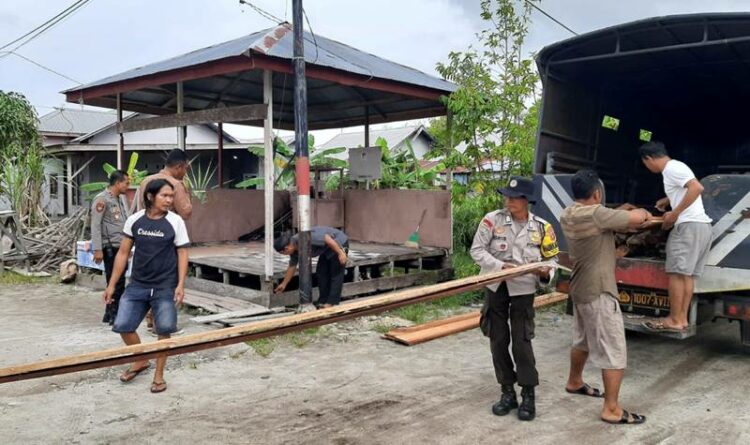 Teks Poto: Jajaran Kapolsubsektor Jekan Raya, pada saat menyalurkan bantuan material kepada Pos siskamling di Kelurahan Petuk Katimpun